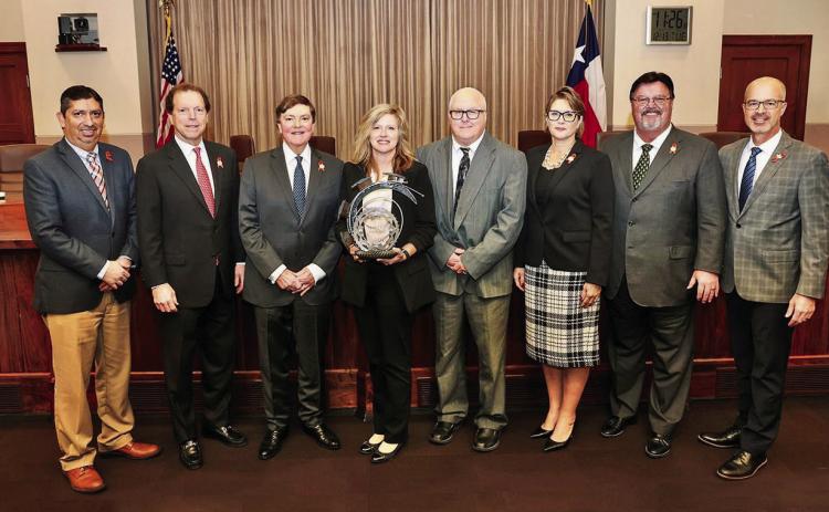 Texas Department of Transportation (TxDOT) Childress District Traffic Safety Specialist Nicole Tyler, center, is presented with the GRIT Award by the Texas Transportation Commission Tuesday, Dec. 13 in Austin. From left: Director of Traffic Safety Michael Chacon, Commissioner Robert C. Vaughn, Chairman J. Bruce Bugg, Jr., Tyler, Childress District Engineer Darwin Lankford, Commissioner Laura Ryan, Commissioner Alvin New and Texas Department of Transportation Executive Director Marc Williams. Courtesy Photo