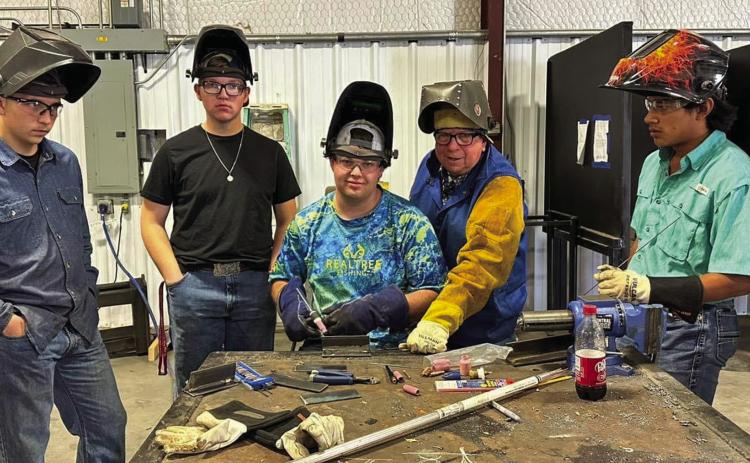 Clarendon College Director of Industrial Maintenance and Welding Mark Simmons, center, recently visits Memphis High School agriculture teacher Ed Bailey’s class, teaching the students new welding techniques. Photo Courtesy of Memphis ISD