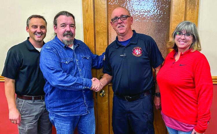The City of Childress welcomes Childress Fire Department Chief Ralph Freeman Monday, Nov. 18. From left: Childress City Manager Kevin Hodges, City of Childress Mayor Cary Preston, Freeman, Mischi Freeman. The Red River Sun/Elizabeth Tanner