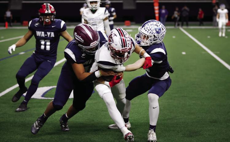 Wa-Ya defensive back Cooper O’Neal, right, of Wills Point High School, tackles Ta’Tanka wide receiver TJ Salinas (center), of Wellington High School, during the first half of the Native American All-Star Football Game at the Ford Center at The Star in Frisco on Tuesday, Jan. 7. Photo by Dallas News Staff Photographer Tom Fox
