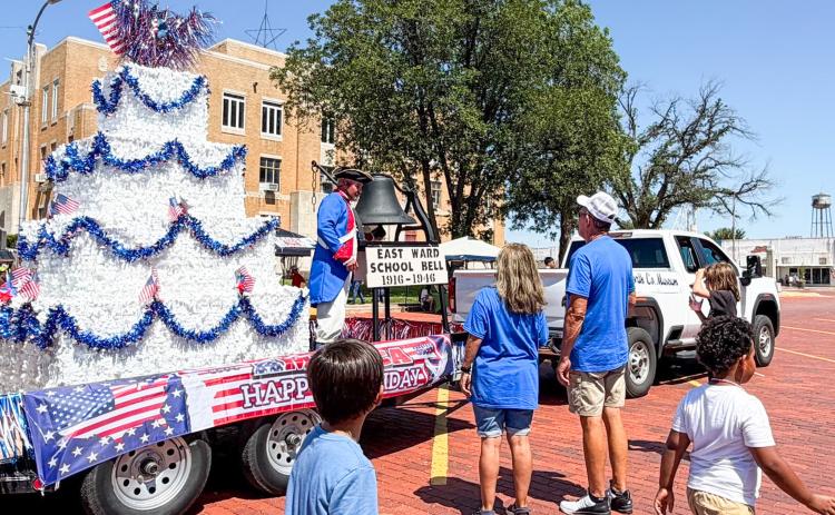 Only a small crowd gathers as Danny Sain, portraying an Early American Patriot Soldier on Collingsworth County Museum’s float, rings the former East Ward School bell at noon Saturday, July 4 in front of the Collingsworth County Courthouse following Wellington’s “Red, White and Boots” parade. Sain rang the bell 25 times, with each ring commemorating 10 years of America’s “let freedom ring” history. BEV ODOM/THE GREENBELT INTREPID
