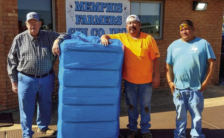 Memphis’ Jim Stewart, left, harvests the first bale of the 2024 cotton crop ginned at Memphis Farmers Gin Cooperative, Inc. Thursday, Oct. 24. Stewart, who also serves the First Baptist Church of Memphis Minister of Music, farms cotton in the surrounding area. A graduate of Memphis High School, he attended West Texas A&amp;M University, where he earned a Bachelor and Master of Arts in Music, which he used to teach music at Clarendon College prior to his retirement. Courtesy Photo