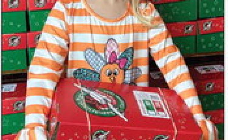 Kellyn Conner, daughter of Jordan and Tucker Conner, helped her grandmother, Wendy Langford, and Rosa Carter pack 50 shoeboxes for delivery to impoverished children around the globe through Samaritan’s Purse Operation Christmas Child ministry. Courtesy Photo