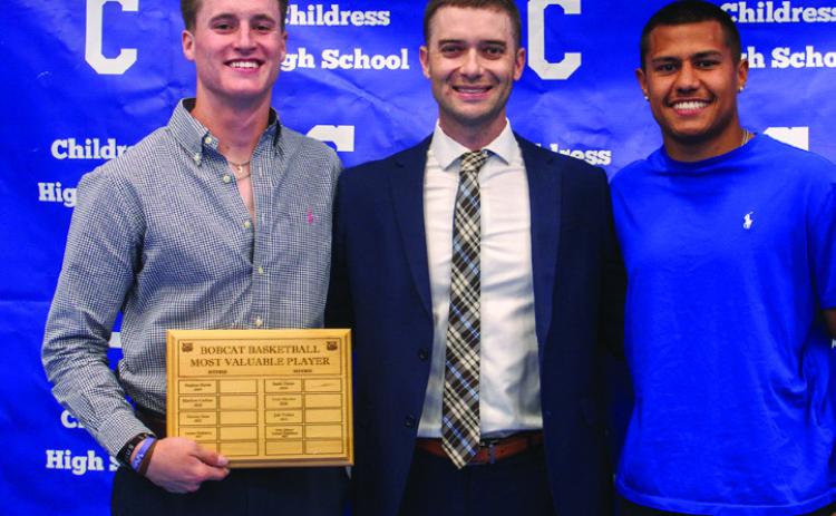 Head boys’ basketball coach Wayne Parker, center, awards Bobcat Basketball Offensive Most Valuable Player Aiden Allen, left, and Bobcat Basketball Defensive Most Valuable Player Isaiah Jalomo, right.