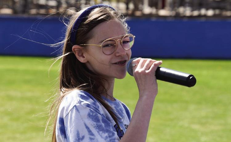 Play ball! Monson Music Studio’s Selah Smith, daughter of Stran and Jennifer Smith, of Childress, performs the National Anthem at the recent Childress Lady Cat softball game in Childress. Photo by Lori Rabe