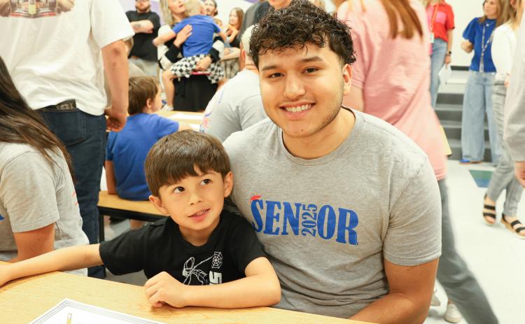 Kindergarteners, seniors team up for Kindergarten Signing Day