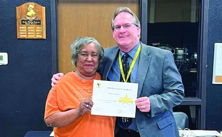 Memphis High School Instructional Assistant Sharon Hearn receives March Employee of the Month recognition during a recent Memphis Independent School District (ISD) Board of Trustees meeting. Hearn is congratulated by Memphis ISD Superintendent William Alexander. The Memphis ISD Employee of the Month program is sponsored by First Bank and Trust. Memphis ISD