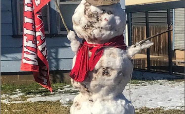 Skyrocket fans in the 1400 block of El Paso St. appropriately attire a snowman, bundled with a Rocket red scarf and displaying a Wellington Skyrocket flag. Huge snowflakes began blanketing Collingsworth County around 8:30 a.m. Monday, Nov. 14. The wet snow fell intermittently throughout the day. The Wellington Skyrockets take on the Sudan Hornets at 7 p.m. Friday, Nov. 18 at Dick Bivins Stadium in Amarillo for the 2A Division II Area Championship. Photo Courtesy of Billy Wilkerson