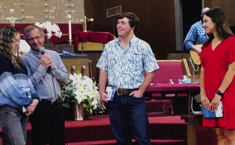 First Methodist Church Pastor Gene Weinette questions members of the Wellington High School Class of 2025 concerning their future plans during the Sunday morning, April 27 worship service. After he presented each with a Bible, he offered the young adults a bit of advice concerning skipping class. From left, Kenzi Ballinger, Weinette, Caleb Strickland and Emma Flores. The Red River Sun/Bev Odom