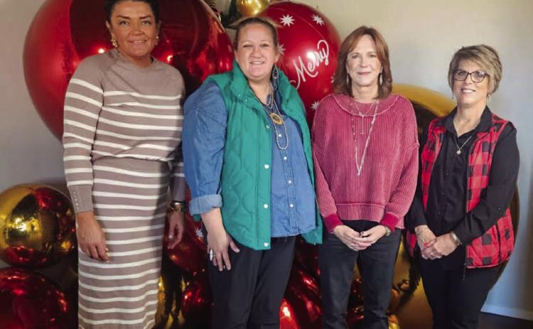 Host Brooke Carter, left, with Hearts United Give Support (HUGS) volunteers Whitney Wiebe, Marcy Sessions and Donnie Carter, welcome visitors for the Holiday Home Tour on Sunday afternoon, Dec. 7. Hearts United Give Support