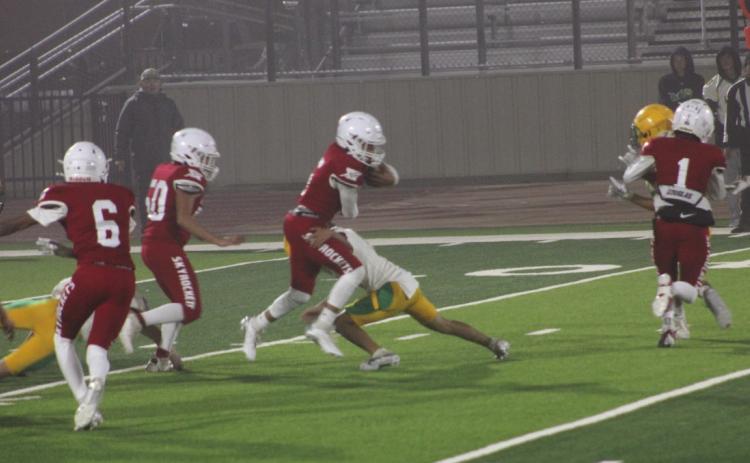 Wellington junior varsity Skyrocket Alex Orozco (5) gains yardage in the game versus New Deal in Floydada last Thursday, Nov. 7. Wellington won the game 22-18 as officials called the game in the third quarter due to heavy rain. Other Rocket blockers included Carson Kane (1), Jr Vega (50) and Troy Molina (6). The Red River Sun/Shauna Salinas