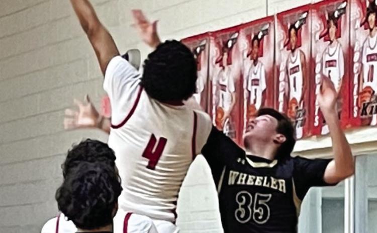 Wellington Rocket Jordan Nation (4) jumps to put points on the scoreboard against Wheeler Tuesday night, Jan. 31 with Braylon Tarver (12) ready for the rebound. The Red River Sun/Shauna Salinas