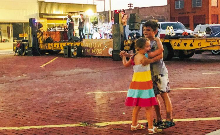 Siblings Savannah Tralie, 5, and Max Tralie, 7, two-step to Biscitheadz Saturday night, June 17, on the bricks of downtown Wellington. Big brother Graham Tralie attended as well. In town for “Nana Camp” with their nana, Lanna Reeves, of Wellington, the children’s parents are Rachel and Jarrod Tralie, of the Houston area. The Red River Sun/Bev Odom