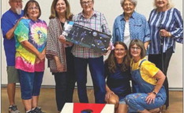 Sharon Starkey garners highpoint individual honors, winning a light-up cornhole game, at the recent September Wellington Senior Citizens Center social. Cornhole winners gather for a fun shot at the end of the evening. Front row, from left: Karen Caldwell, Dawn Dockter. Back row, from left: David and Kim Lambert, Margret Wood, Starkey, Katherine Reeves, Vada Wood. Not pictured: Billy Colson, Les and Lisa Freeland, Genevieve Patterson, Linda Powell, Marie White. Courtesy Photos