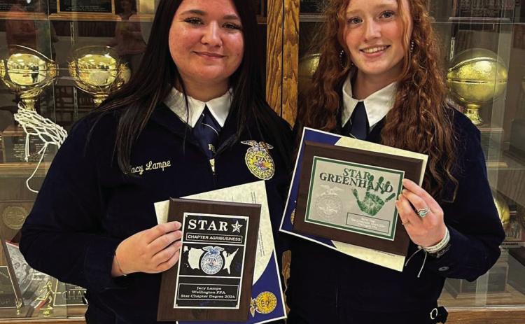Sophomore Jacy Lampe, left, and freshman Bailey Page accept some of the top honors at the Wellington Future Farmers of America (FFA) Awards Banquet, held Wednesday, May 7 in the Wellington High School Commons. Among other awards, Lampe received the Wellington FFA Star Chapter Degree 2024, while Page accepted the Star Greenhand accolade. Courtesy Photo