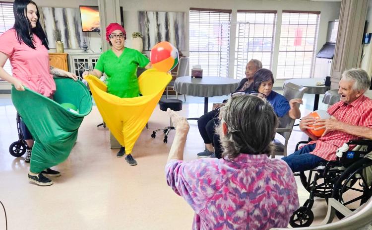 Situated in the dining room and attired in “Granny Pants,” Wellington Care Center staff encourage residents to toss balls into oversized, wearable pants. Fun and laughter filled the room, and everyone had a great time working together, staying active and sharing plenty of smiles. Wellington Care Center
