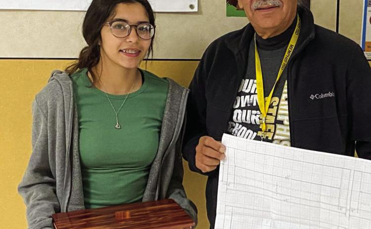 Memphis Middle School eighth-grader Alexis Diaz shows off her recent woodworking skills, which she learned in educator Ramio Salas’ class. Diaz designed, drew up and built the project. Photo Courtesy of Memphis ISD