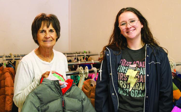 Childress County Christmas Sharing Board Members Raenell Smith, left, and Haley Richardson, right, prepare for the 2024 holiday season, which met the needs of 50 families, 96 children, 18 high-school students and 47 elderly and disabled, as well as Childress Healthcare Center and Cottage Village Assisted Living residents. The Red River Sun/Elizabeth Tanner