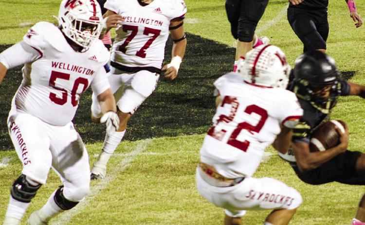 Skyrocket Enrique Jaimes (22) tackles a Mustang with Blake Strickland (50) and Rey Ramirez (77) also coming in, defensively shutting out the Mustangs in 64-0 final. Wellington moves to 7-1 overall and 3-0 in district play. The Red River Sun/Shauna Salinas