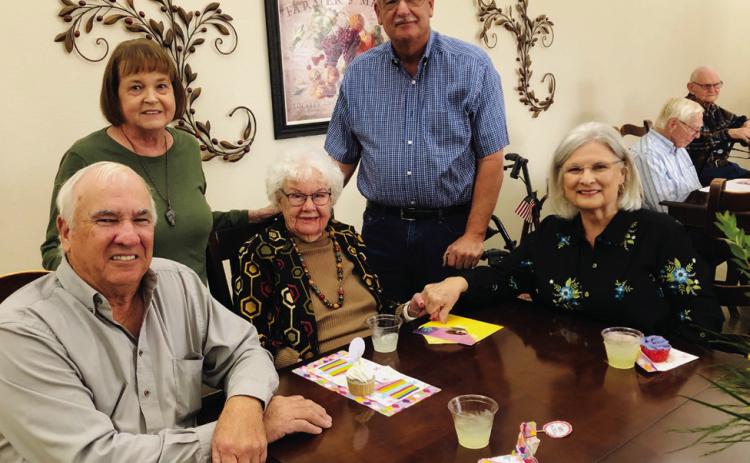 In the dining room of Wellington’s Parkview Manor Assisted Living, Helen Parker, center, celebrates her 103rd birthday on Monday, Nov. 18. From left, son and daughterin- law Gary and LaDonna Oldham, of Samnorwood; the honoree; nephew Clinton Oldham, of Winnie; and niece Rosa Carter, of Wellington. The Red River Sun/Bev Odom