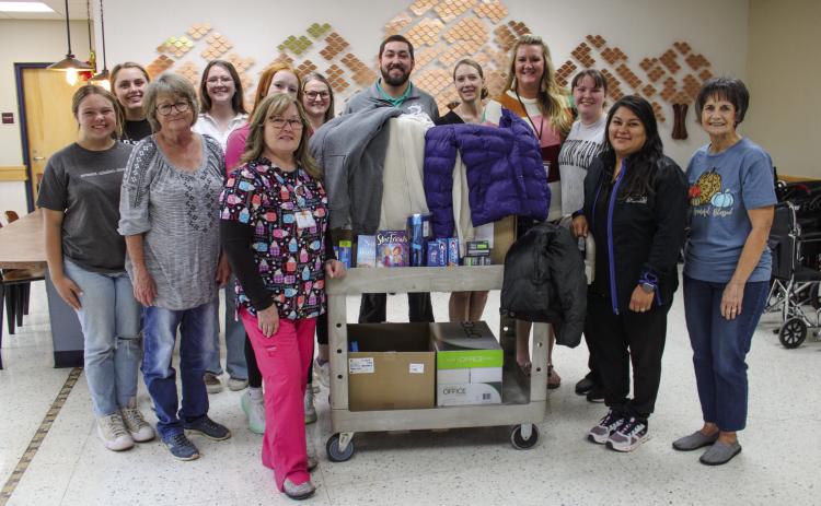 Childress High School (CHS) Family, Career and Community Leaders of America (FCCLA) members, including Emma Britten, Adlee Lambert and Jillian Pierce, pick up coat drive donations at Childress Regional Medical Center Wednesday, Nov. 8. The donations, ranging from coats to personal hygiene items, were contributed to Childress County Christmas Sharing’s Winter Coat Giveaway. The Red River Sun/Elizabeth Tanner
