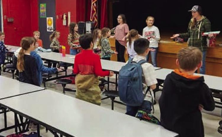 Collingsworth County 4-H Club Officers Brylnn Kemp and Ava Kate Inman open the Tuesday, Feb. 7 meeting, assisted by Club Manager Molly Sims. Courtesy Photos