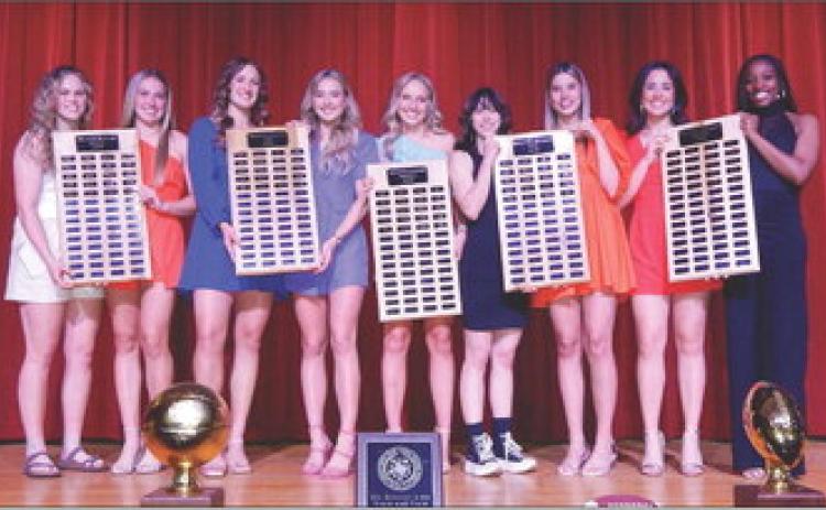 Wellington Lady Rockets, including Briley Waters, left, Kaitlin Bawcom, Audrey Jones, Madeleine Kane, Presley Kane, Addy Mock, Charley Wilbur, Summer Owens and Asia Shrubs, accept special recognition during the 2023 Athletic Banquet. The Red River Sun/Bev Odom