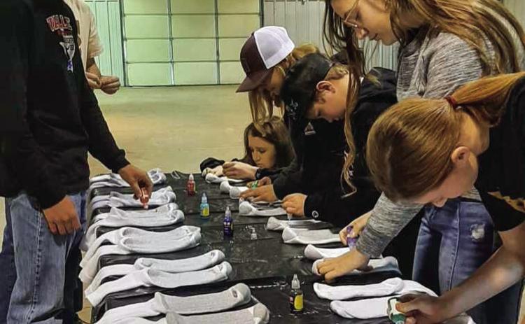 Hall County 4-H members create non-slip socks for Memphis Convalescent Center residents at the recent December club meeting, which was held Sunday, Dec. 11 at the Hall County Show Barn. Photo Courtesy of Hall County 4-H