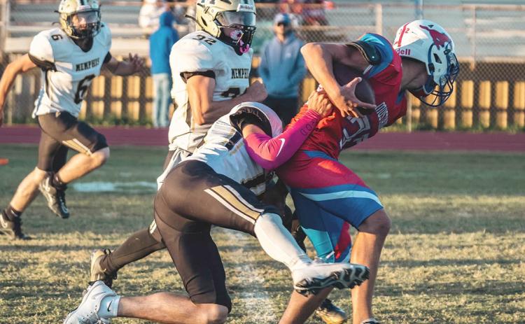 A Cyclone football player takes down a JV Claude Mustang last week during Memphis’ victory. PECOS BALLARD PHOTOGRAPHY