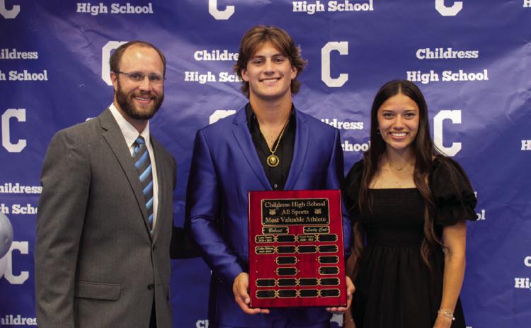 Childress Athletic Director Bo Helm, left, awards Best All-Around Bobcat Athlete Scout Smith, center, and Best All-Around Lady Cat Athlete Clarissa Gamboa, left, at the 2023-2024 All-Sports Banquet Monday, May 20. The Red River Sun/Elizabeth Tanner