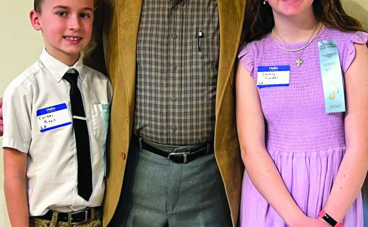 Monson Music Studio students Carter Keys, left, and Jentry Souder, right, compete in the Wichita Falls Spring Music Festival Saturday, March 4 at Midwestern State University. The students are coached by Gerald Monson, center, owner of Monson Music Studio. Courtesy Photo