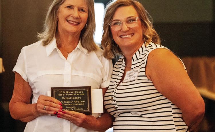 Kathy Sanders accepts the 2024 Rocket House Hall of Fame distinction in honor of her late husband, Richard Sanders, presented by Lana Tillman, a member of the Wellington Ex-Student Association Board of Directors Nicole Yarborough Photography
