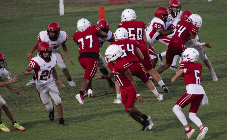 Wellington junior varsity Skyrocket Major Brown (6) attempts a pass with blocking by Kingston Molina (51), Yobani Moreno (77), Hunter Hedrick (54), Dixon Dugan (50) and KJ Molina (64) in the match against Borger Thursday, Oct. 5 at Powell Field. The Rockets moved to 6-0 overall, thanks to a big 40-0 win over the Bulldogs. The Red River Sun/Shauna Salinas