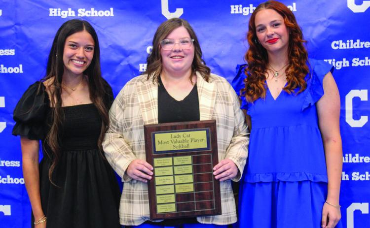 Head softball coach Amanda Wilson, center, awards Lady Cat Softball Offensive Most Valuable Player (MVP) Clarissa Gamboa, left, and Lady Cat Softball Defensive MVP Ansley Parr, right.