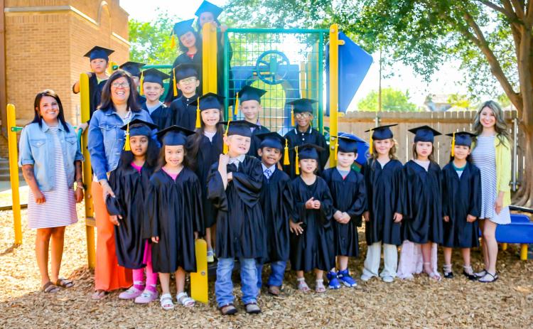 Suited in caps and gowns, the Austin Elementary School Class of 2029 waves goodbye to kindergarten. KKR PHOTOGRAPHY