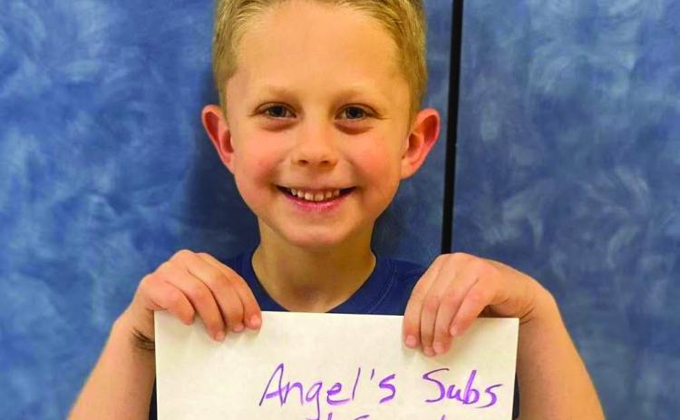 Kindergartener Will Patterson accepts the Angel’s Subs &amp; Sweets gift certificate on behalf of his mother, Abby Williams. Around 150 parents joined their children for lunch Friday, April 4 for Go Blue Day. Visitors registered for gift certificates provided by the restaurants and the Collingsworth County Child Protective Service Child Welfare Board. Wellington Elementary School