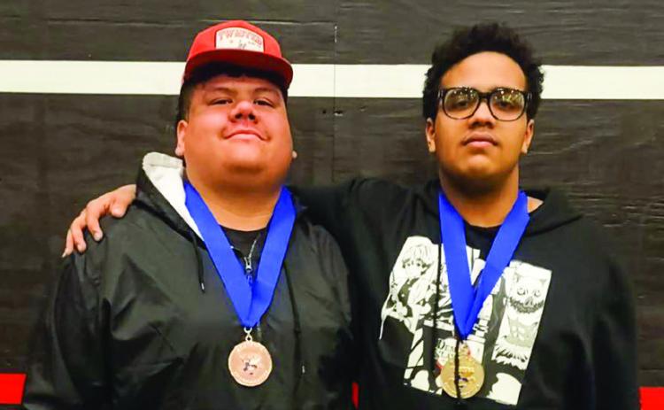 Memphis’ Mike Thomas, right, punches his ticket to the Texas High School Powerlifting Association State Championships, thanks to a first-place finish in weight class 275, during the Region 1 Division 4 Meet Thursday, March 6 in Brownfield. Teammate Eli Martin, left, finished third in the super heavy weight class, securing a spot as an alternate. Memphis ISD