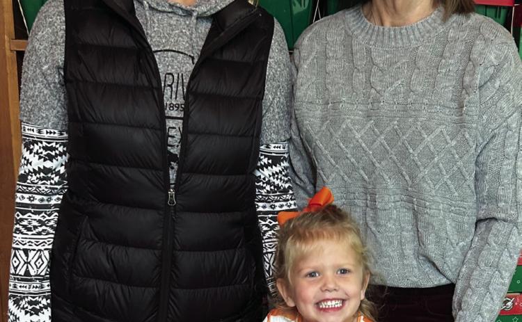 Three generations, including Jordan Conner, Wendy Langford and Kellyn Conner, prepare to transport 100 shoeboxes packed by the Wellington First Baptist Church congregation for delivery around the globe to impoverished children by Samaritan’s Purse Operation Christmas Child ministry. Courtesy Photo