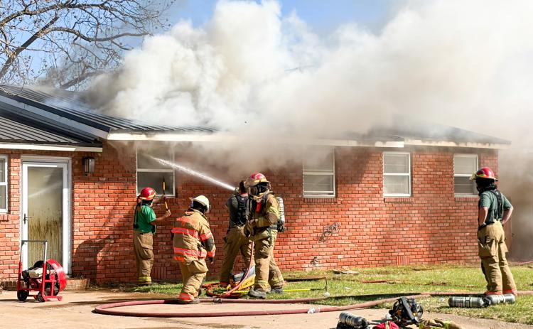 Collingsworth County Sheriff’s Office dispatchers received 911 call at 3:08 p.m. Thursday, March 19 for a house fire in the 1100 block of Haskell St. As temperatures hovered around 100 degrees, the Wellington Volunteer Fire Department responded with 13 firefighters and seven units, along with Constable Ronnie Ward, Wellington Emergency Medical Services and the Texas Department of Transportation. Flames flared up from the metal roof as firemen battled the blaze. The Red River Sun/Bev Odom