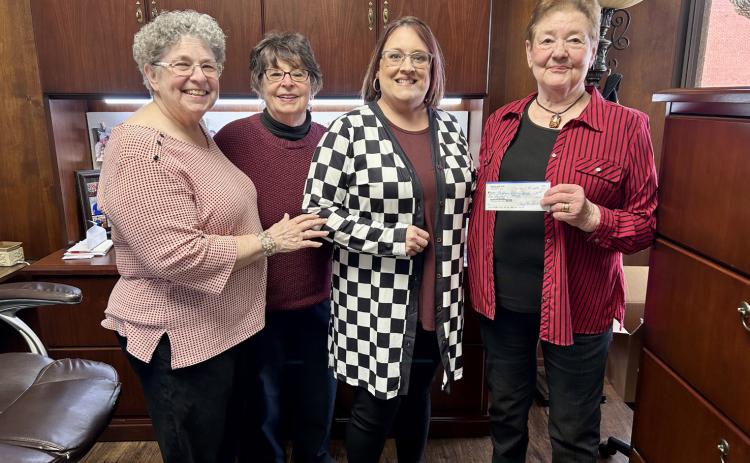 Modern Home Club representatives present a check to Childress Helping Hands’ Kacy Crouch. Courtesy Photo