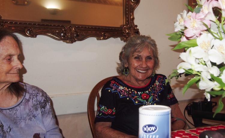 Karen Cornett, right, beams after calling “Bingo!” upon achieving a blackout bingo card at the weekly playing session at Cottage Village Assisted Living Facility in Childress. At left is a regular player, Chick Steed. This week’s caller was Celia Parker, stand-in for Anne Fromm, usual caller of the Tuesday afternoon games. Friends and relatives of Cottage Village residents are usually on hand, joining in on the fun. Photo by Grace Holman
