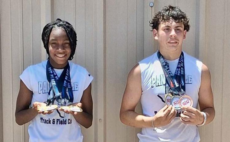 Texas Panhandle Track and Field Club’s Aija Johnson and Juno Castillo show off their hardware at the RUN West Texas track and field meet Saturday, June 14 at River Road High School in Amarillo. Texas Panhandle Track and Field Club