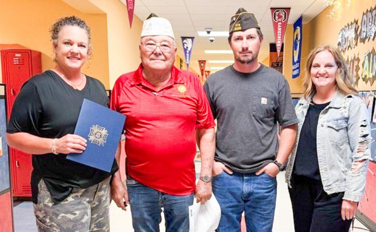Presented by Glynn Moore Veterans of Foreign Wars (VFW) Post 6439 Quartermaster Jr. Castillo and Senior Vice Commander Johnny Davis, Wellington Elementary School (WES) third-grade teacher Carrie Skelton receives the Smart/Maher VFW National Citizenship Education Teacher Award, witnessed by WES Principal Deidre Kane. Skelton’s nomination won at the District Level and has advanced to the State Level. From left: Skelton, Castillo, Davis, Kane. Wellington Independent School District