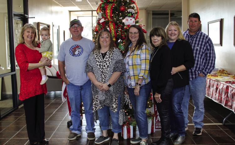 Childress Municipal Development District, along with Global Well Control, George Butler Associates (GBA) and Pease River Ventures, hosts a Holiday Open House at their newly opened location, 501 Commerce St. NW, Thursday, Dec. 8. From left: Carla Springer with granddaughter Corabelle Brown, Gary Clark, Kelly Taylor, Donna Anders, Linda Shaw, Sheabree Nix, Craig McClendon. Not pictured is Dane Fuller. The Red River Sun/Elizabeth Tanner