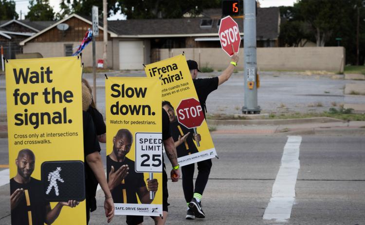 During the deadliest month of the year for pedestrians, the Texas Department of Transportation targets areas of high pedestrian activity and previously reported pedestrian crashes with street teams of “walking billboards,” which display key safety messages for drivers and pedestrians, Monday, Oct. 6 in Childress. Through the Lens of Liz