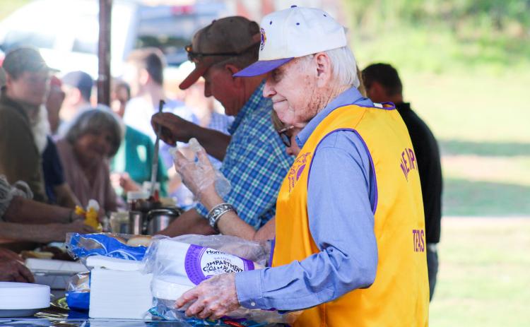 Memphis Lions Club members serve hamburgers at the 69th Annual Park Opener Friday, May 9 at Memphis City Park. ELIZABETH TANNER/THE GREENBELT INTREPID