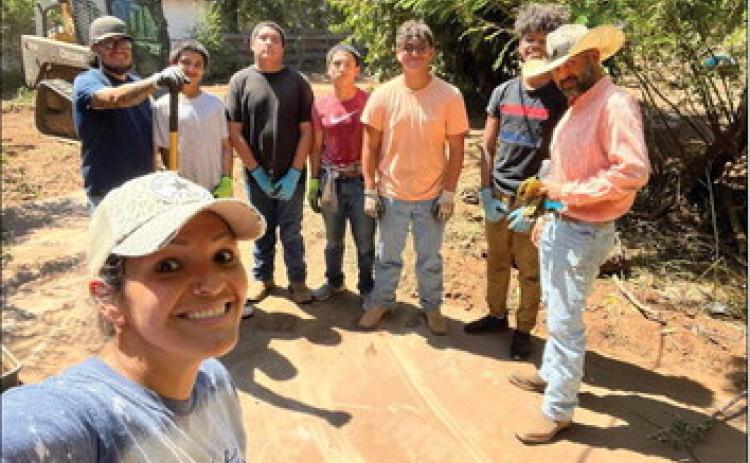 Organizer Becky Reyes, front, takes a selfie of her volunteer team that made a difference in a woman’s life, cleaning up her property and making her home attractive. Back, from left: Amos Molina, Reyes Garcia, Daniel Garcia, Jacob Garcia, Christopher Reyes, Troy Molina and Chris Reyes. Courtesy Photo