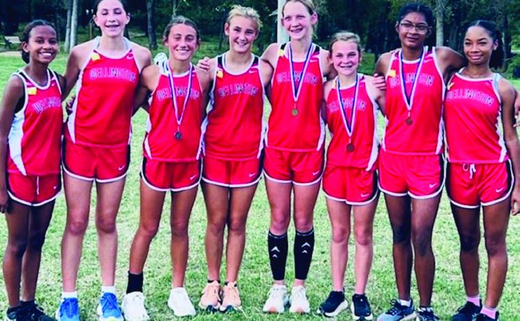 Courtesy Photo Under the direction of Coach Karen Fisher, the Wellington Lady Firecracker cross country team captured the district championship Wednesday, Oct. 9 in Wheeler. Kaesyn Kane led the team as the first-place medalist; followed by Claire Kane, second-place; Priscilla Marentes, eighth-place; and Halle Hedrick, ninthplace. From left: Kobee Lewis, Anna Dwyer, C. Kane, Ava Kate Inman, K. Kane, Hedrick, Marentes, Jaylah Menefield.
