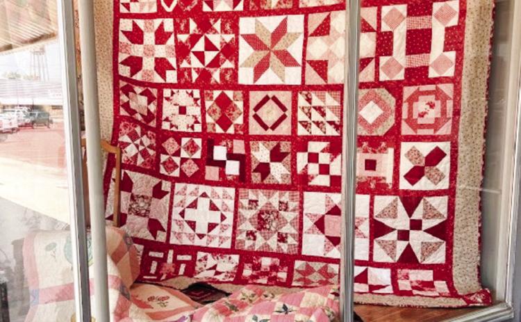 Wellington Methodist Women’s 2024 quilt creation, “Women of the Bible,” graces the display window of the Collingsworth County Museum during the Wild &amp; Free on 83 events in August. Members sold raffle tickets during the affair. Tickets are $5 each or five for $20. For tickets, see Karen Caldwell at the museum or Bev Odom at “The Red River Sun” newspaper office. Tickets will also be sold during the annual bazaar fundraiser event this Saturday, Nov. 2. Courtesy Photo
