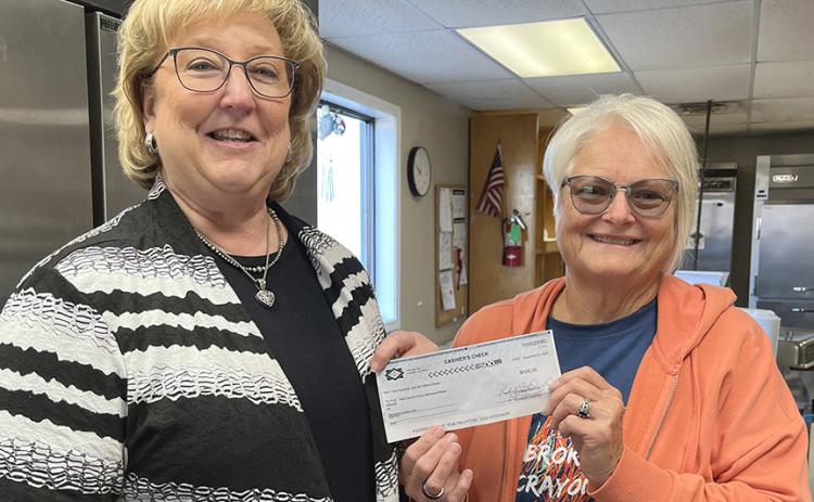 Memphis Country Club Board Member Kelli Little presents a check for $500 to Hall County Home Delivered Meals Director Kila Manuel. The money was the proceeds from the Memphis Country Club’s Poker Run held during Hall County Picnic last month. INTREPID PHOTO / CINDY WOODARD